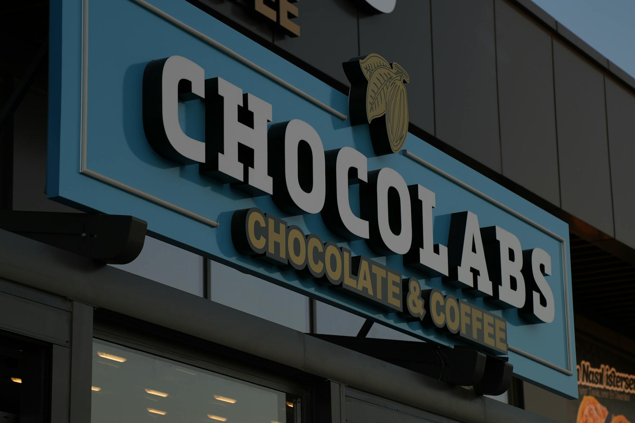 Storefront signage for Chocolabs, highlighting chocolate and coffee offerings.